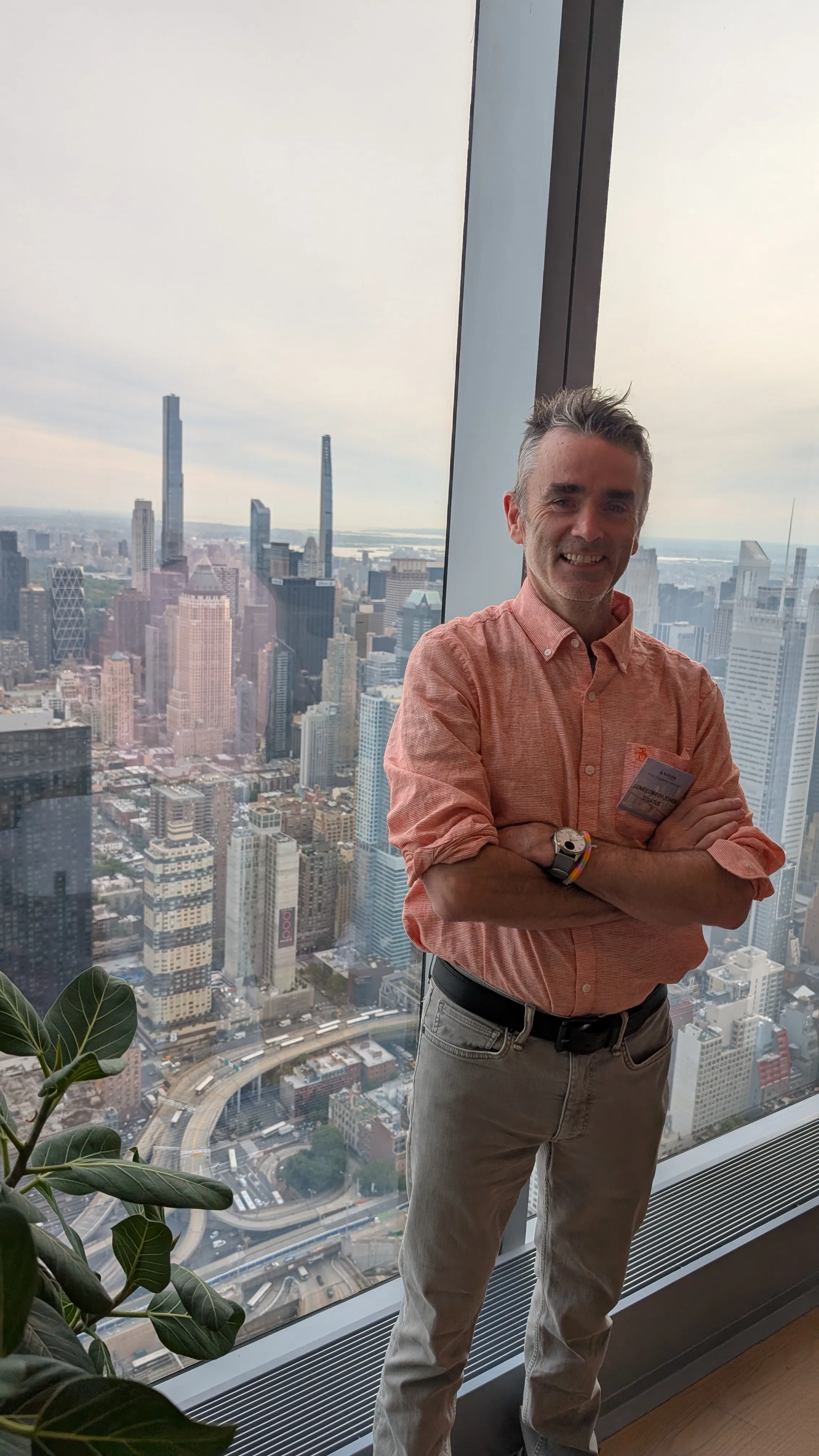 Gene Conroy-Jones overlooking the New York City skyline from a high-rise office