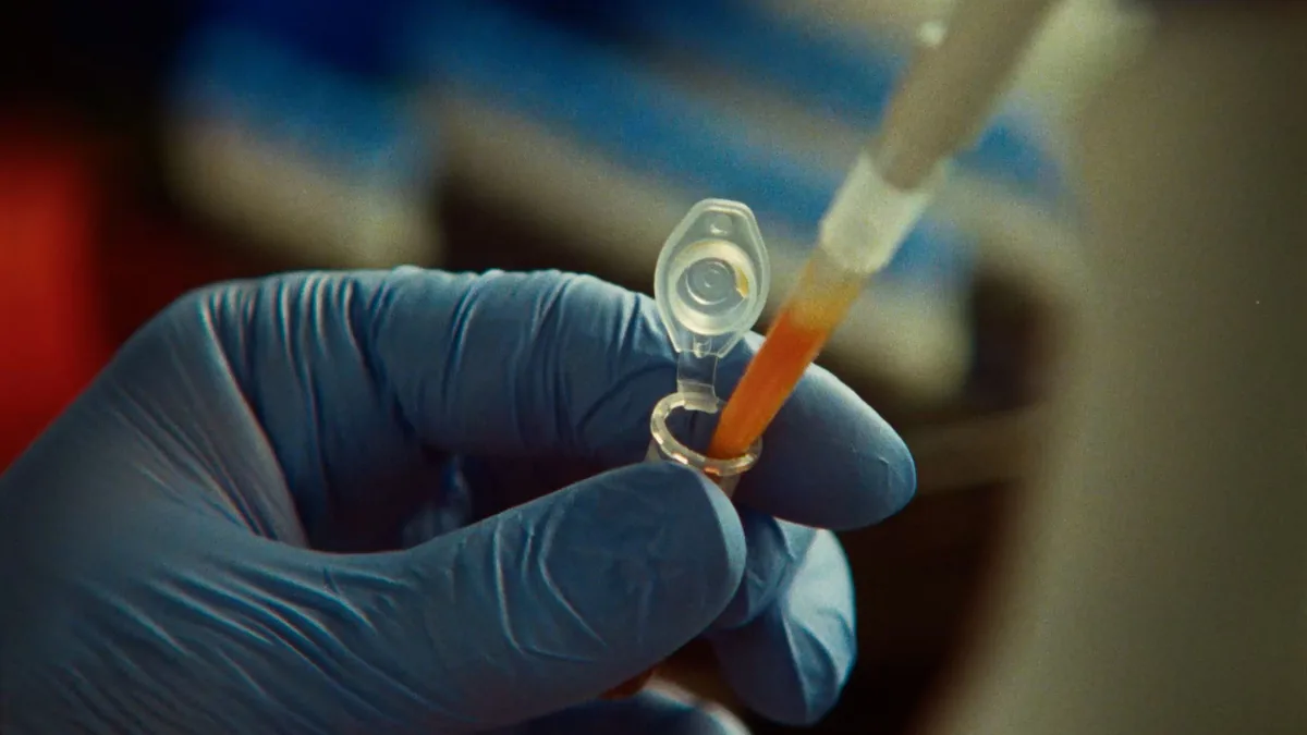 A scientist pipetting