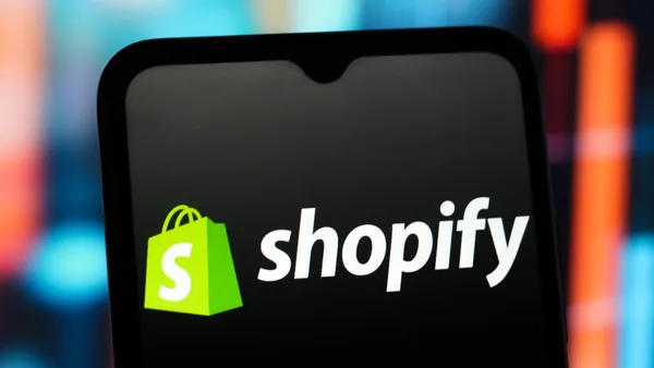 In this photo illustration, the Shopify logo is seen